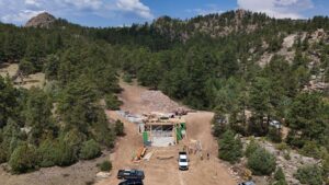 red-feather-builder-early-framing-hillside