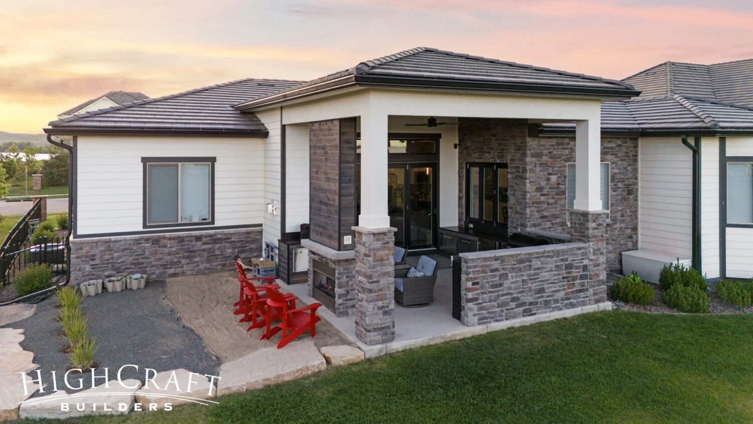 Berthoud remodel covered patio fireplace and bar with grilling station