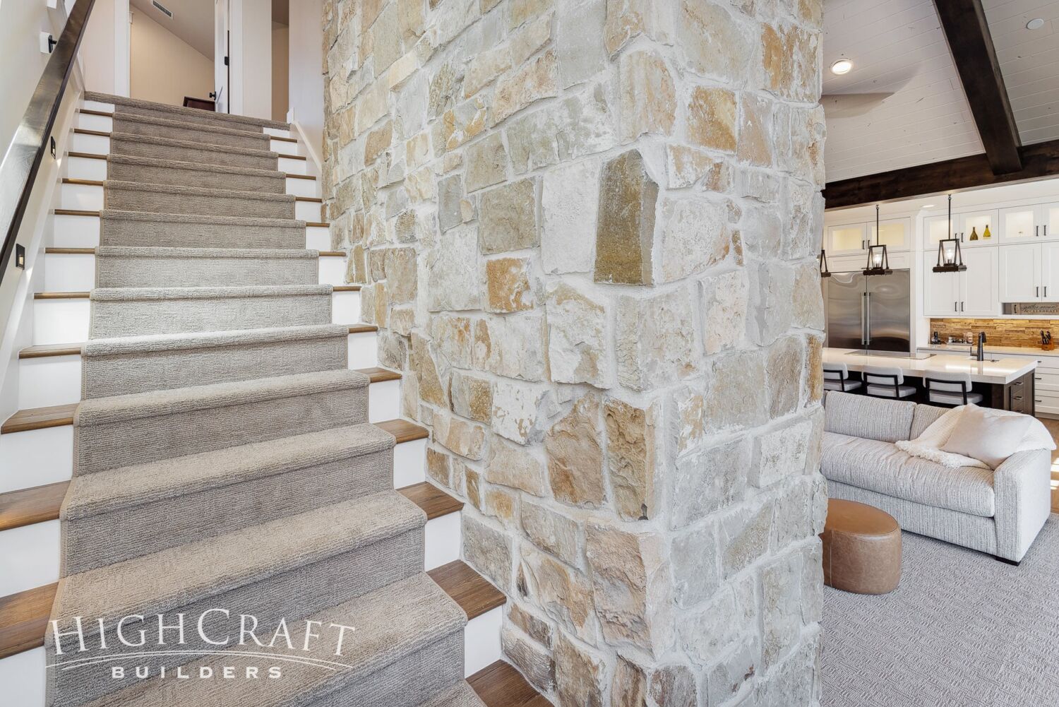 custom-home-builder-mountains-stone-fireplace-wall-stairwell