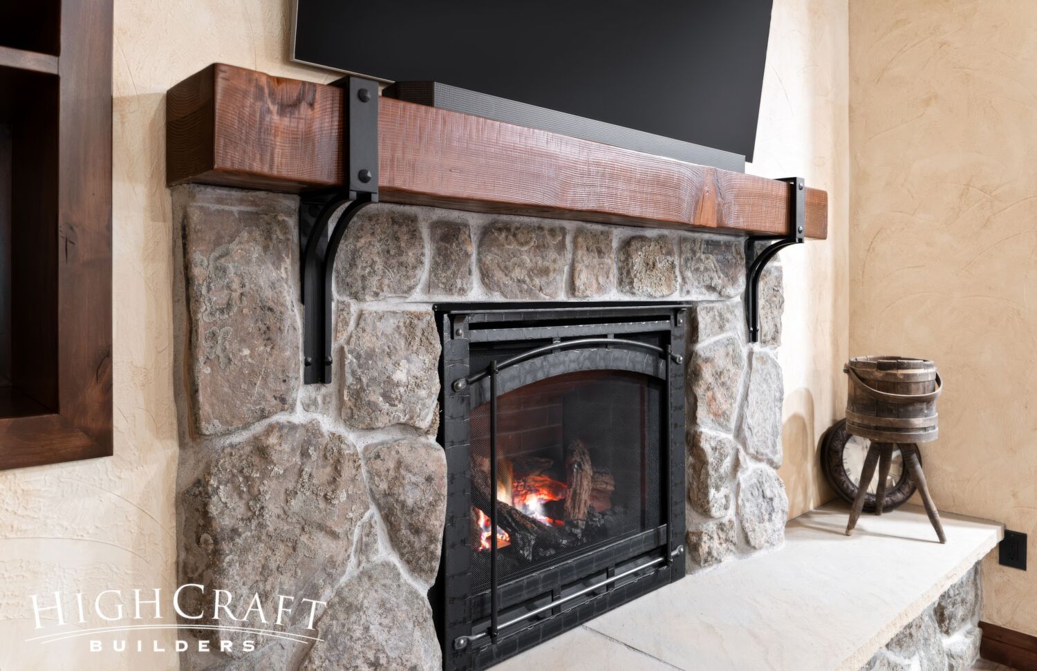 basement-remodel-Fort-Collins-moss-rock-fireplace-rough-sawn-mantel-metal-brackets