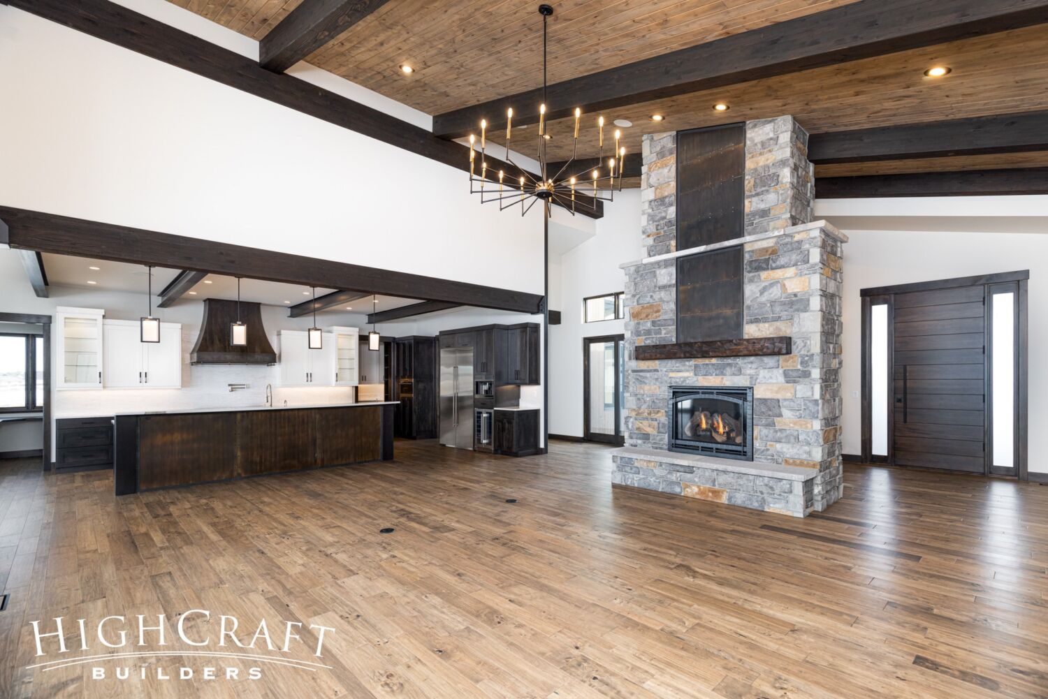 custom-home-builder-Berthoud-vaulted-great-room-fireplace-kitchen