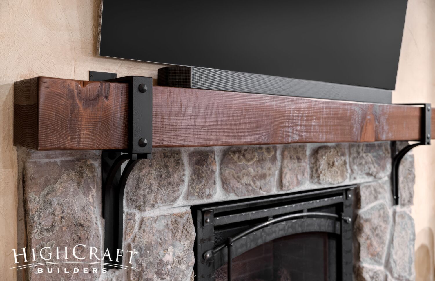 basement-remodel-stone-fireplace-rough-sawn-mantel-black-hardware-closeup